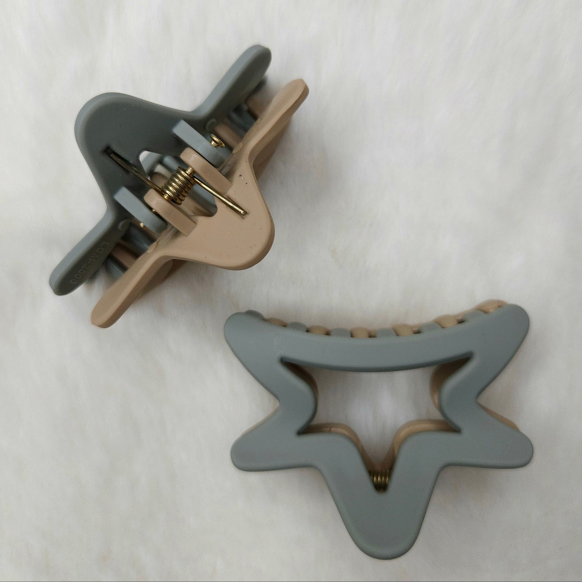 Two gray hair clips on a white background