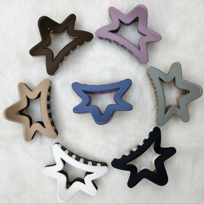 Semi Star-shaped hair claw clips in various colors arranged in a circular pattern on a white background.
