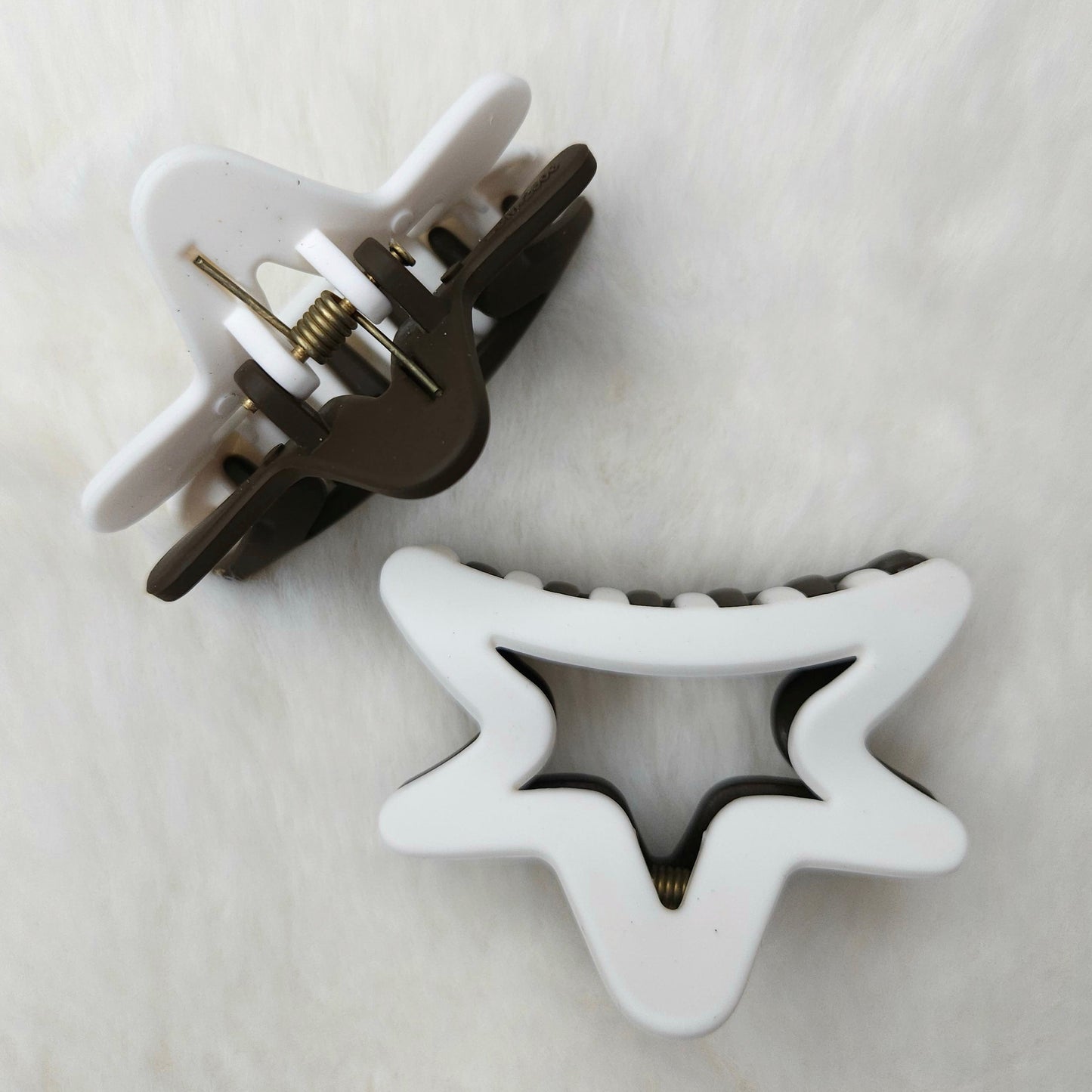 Semi star-shaped hair clips on a white background