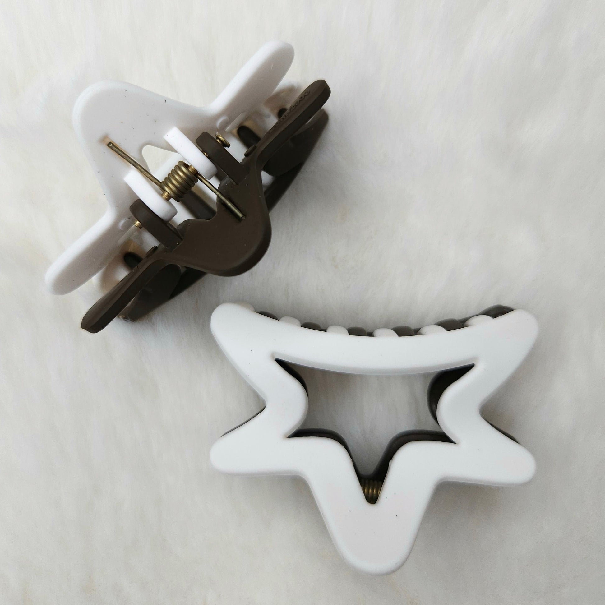 Semi star-shaped hair clips on a white background