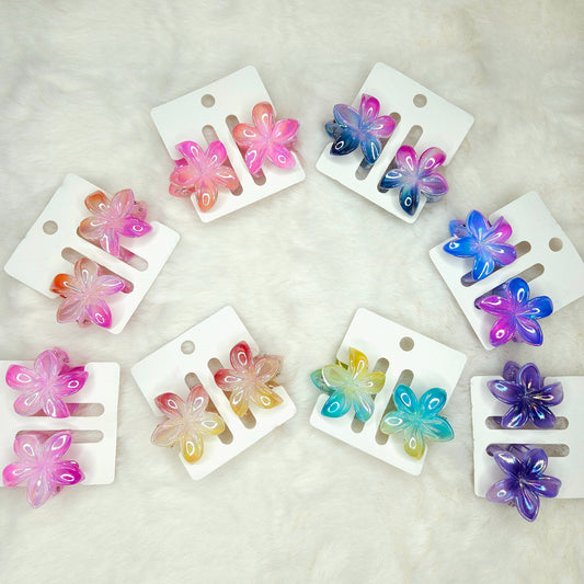 Set of colorful butterfly-shaped hair clips on white cards against a light background