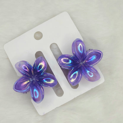 Pair of shiny dual-shade purple mini flower hair claws with iridescent finish, displayed on a white background card.