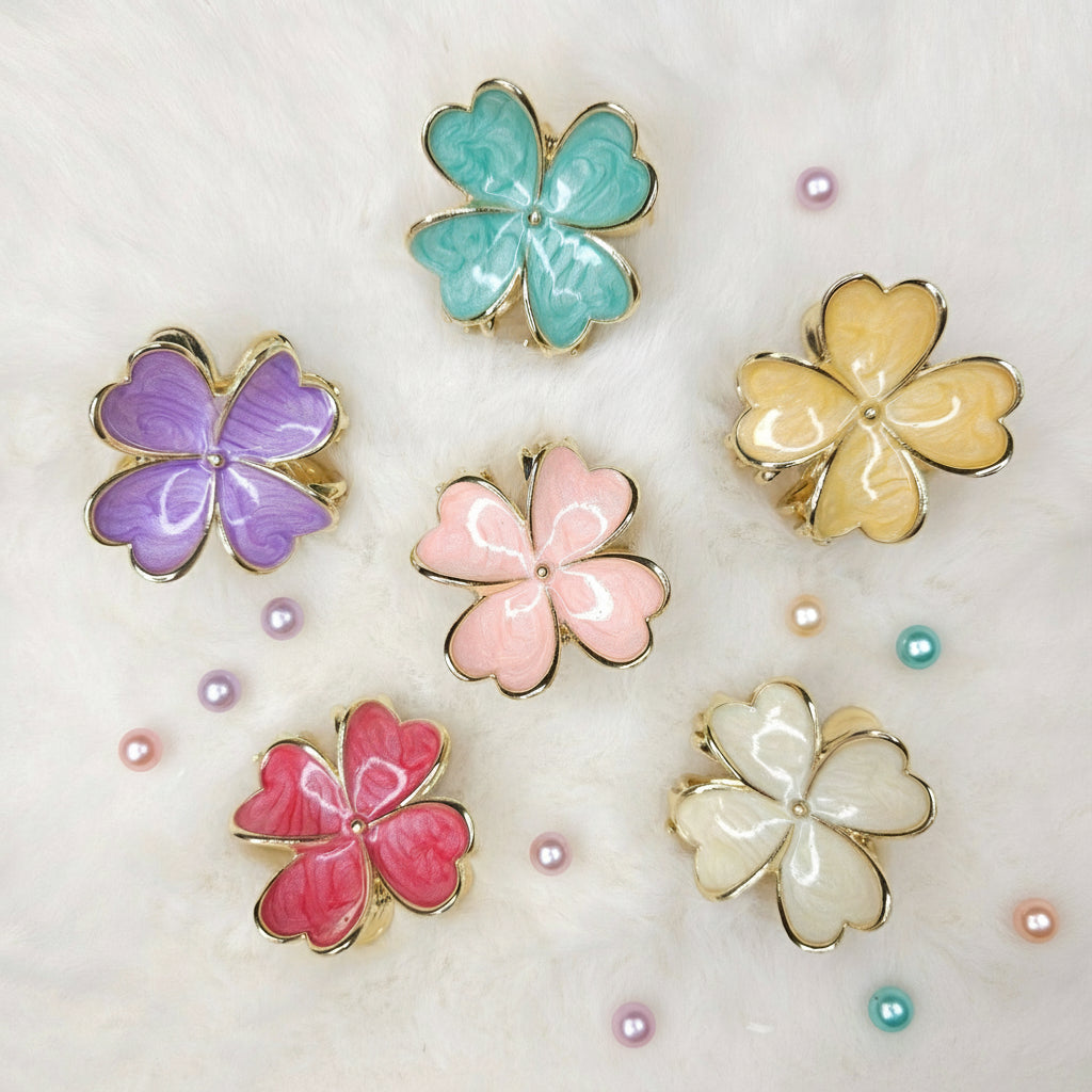 Set of colorful flower-shaped hair claws on a light background