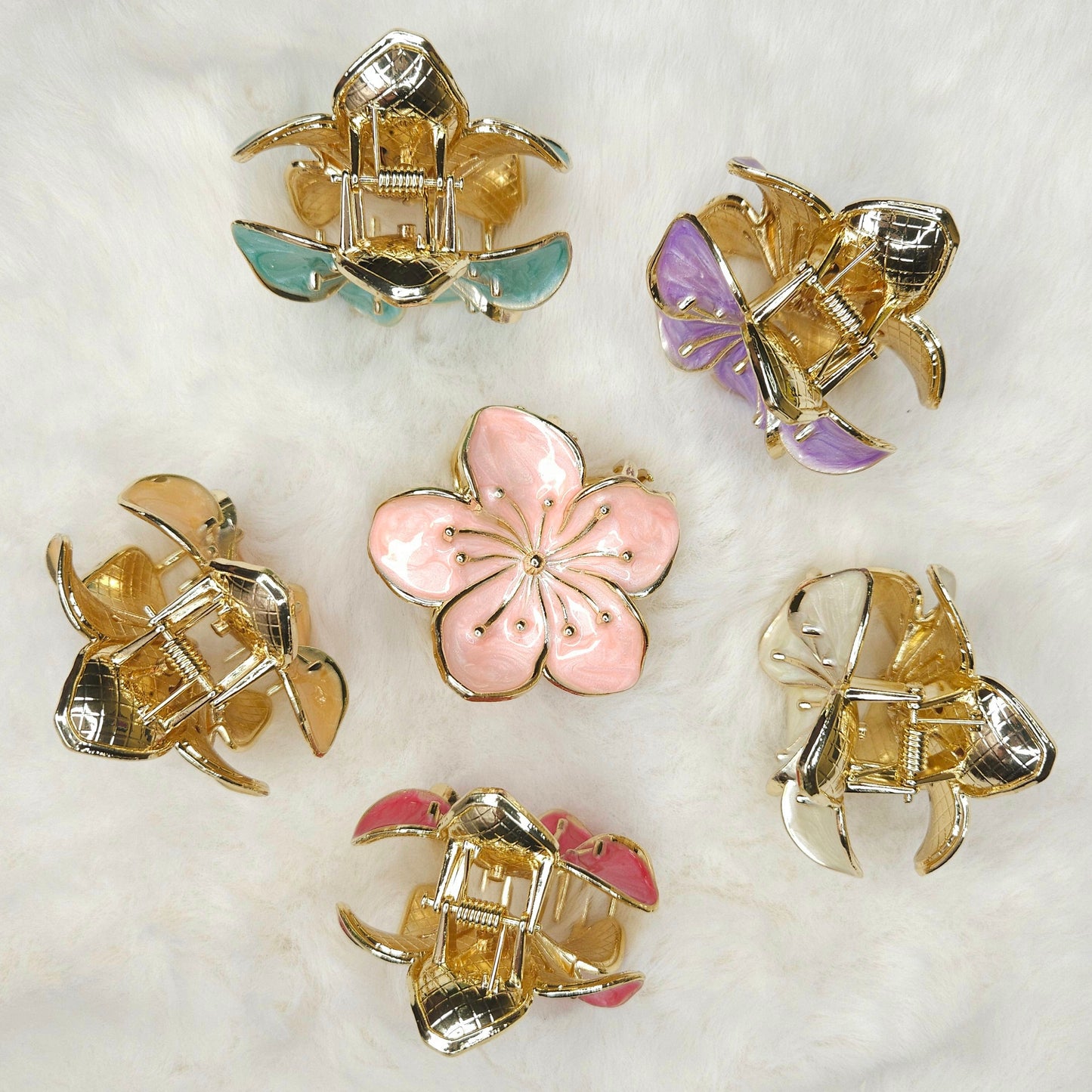 Set of decorative hair claws with floral and architectural designs on a white surface