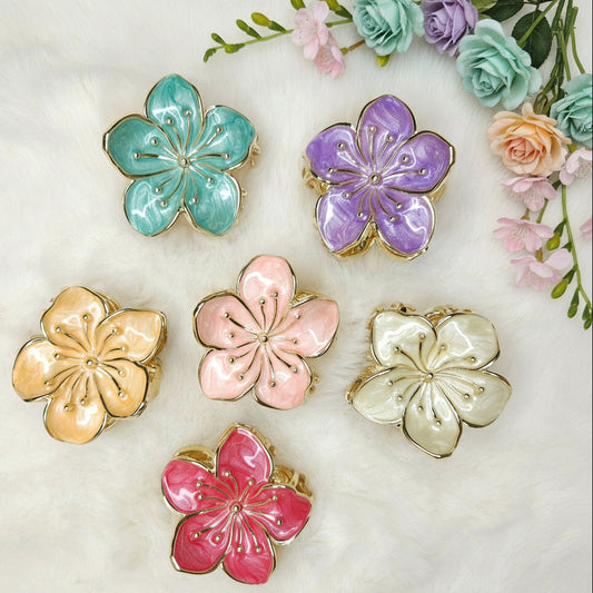 Set of colorful flower-shaped hair claws on a light background