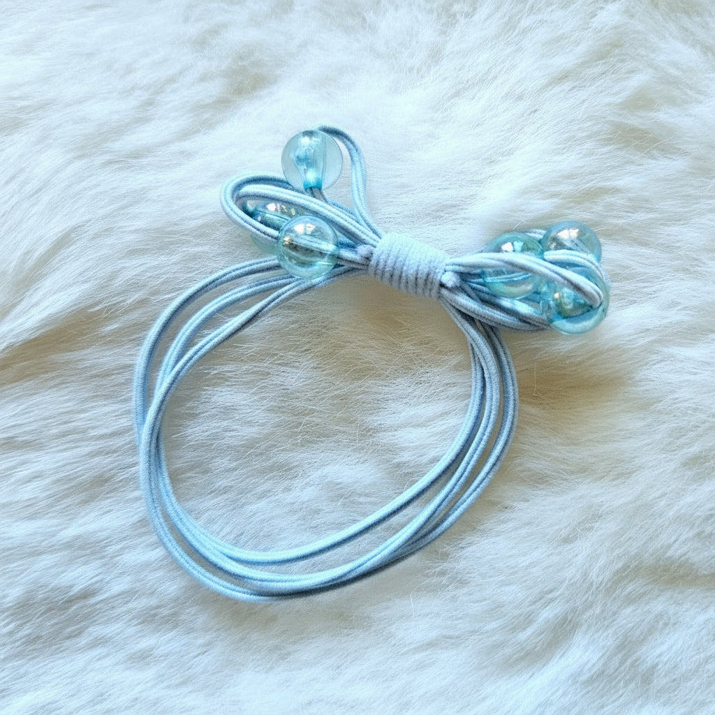 Clear plastic hair tie on a white fur background