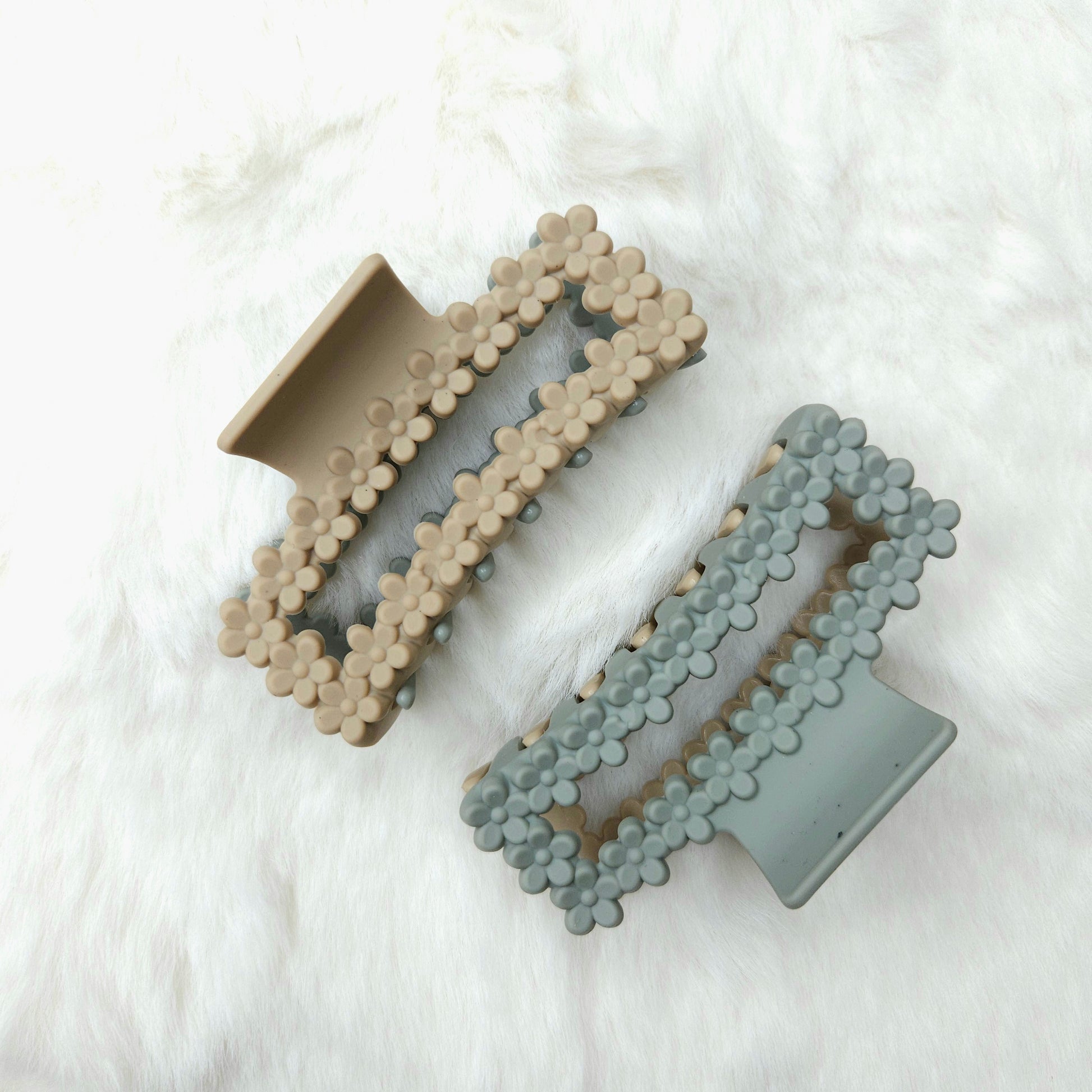 Dual colored rectangular shaped hair claw clips placed on a white background.
