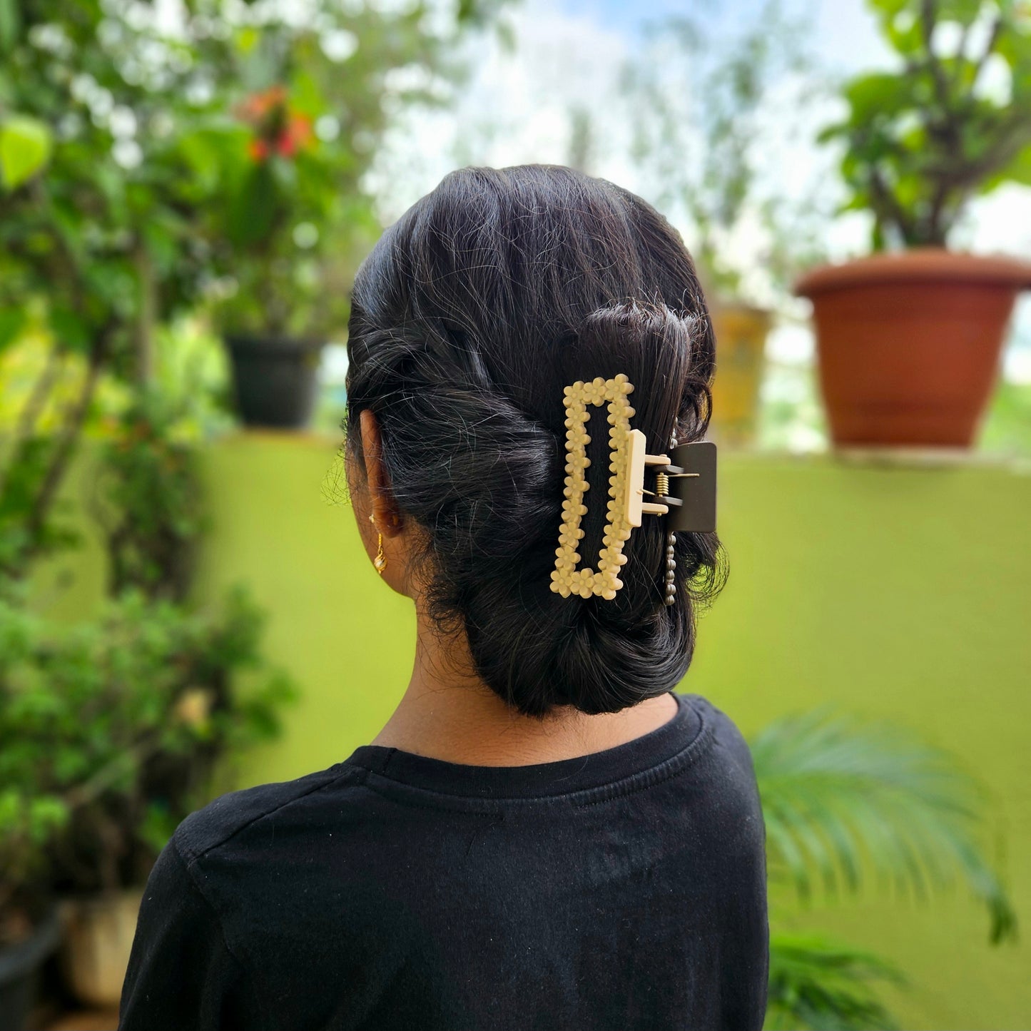 Person with a decorative hair clip standing in outdoors