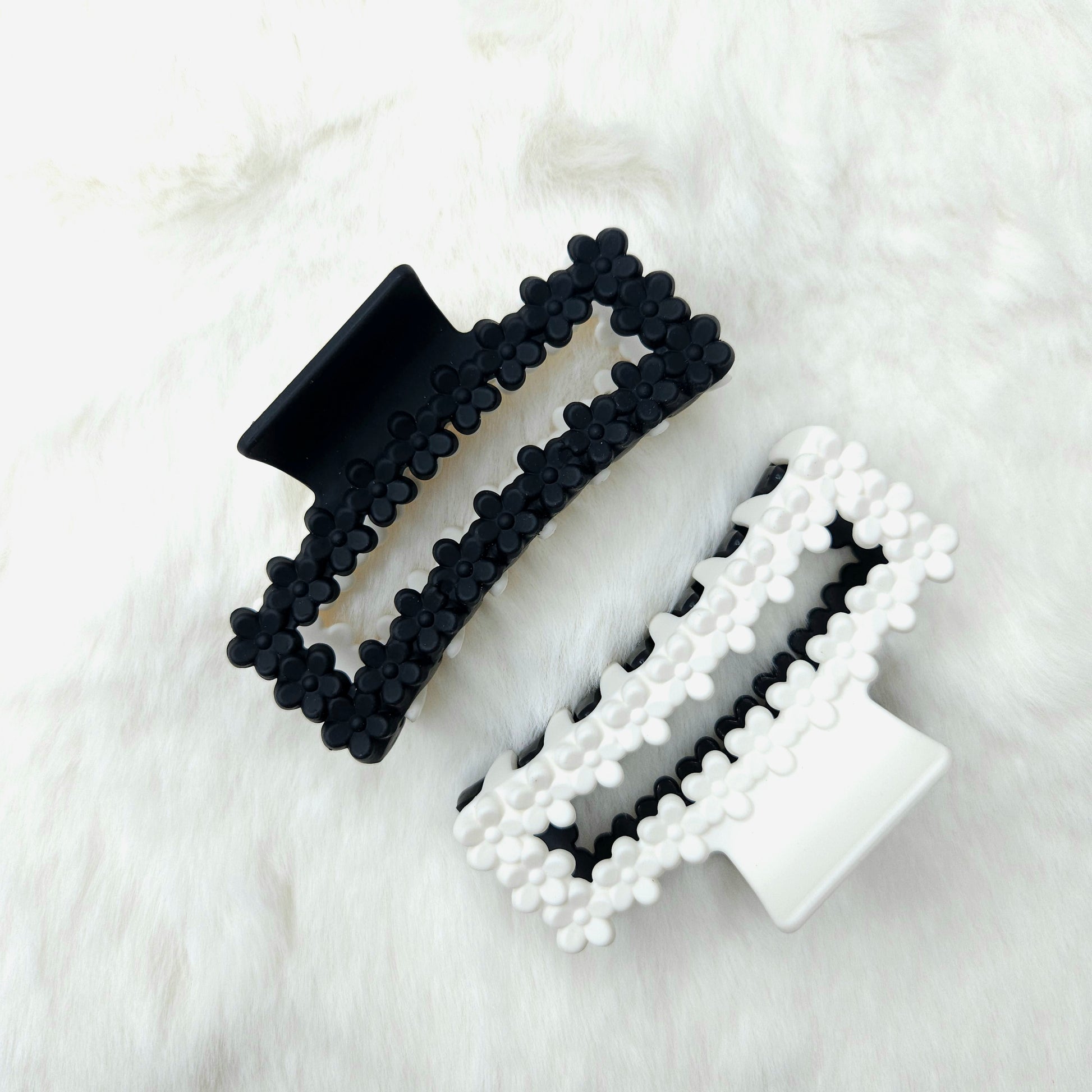 Black and white rectangular shaped hair claw clips on a white background