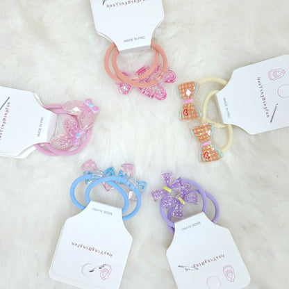 Colorful hair ties on white tags with a soft white background
