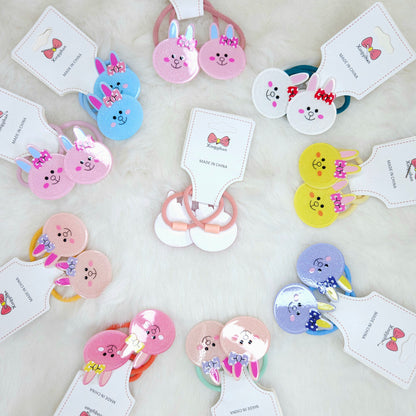 Colorful hair accessories with cartoon designs on a light background