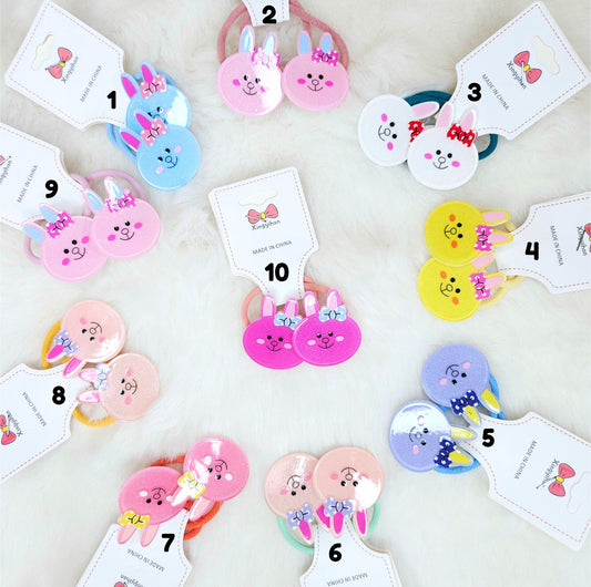 Set of colorful hair bands with tags on a light background