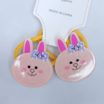Two pink bunny face hair ties with yellow bands on a light gray background, branded 'Xingyihan'.