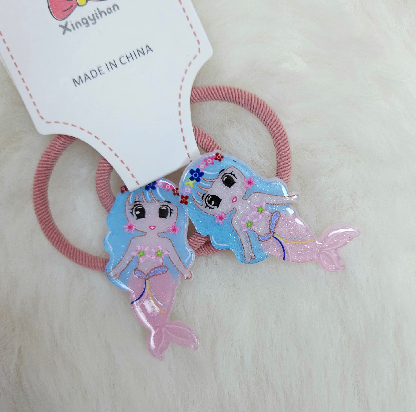 Mermaid-themed hair ties with a 'Made in China' label on a light background