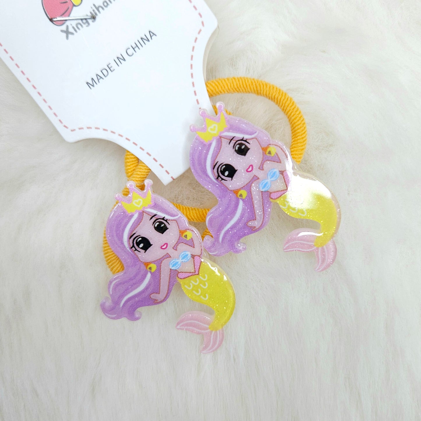 Mermaid-themed hair ties with a 'Made in China' label on a light background