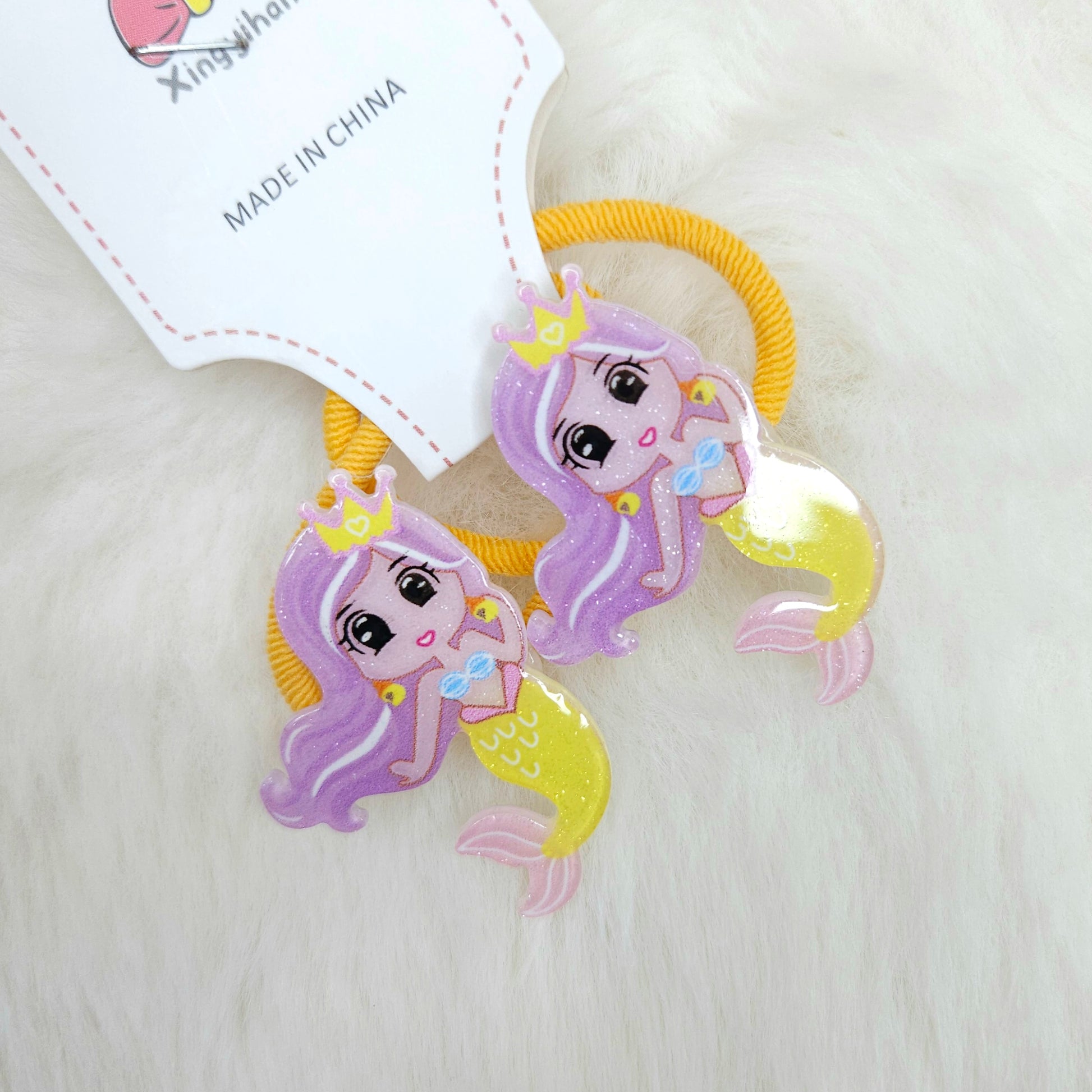 Mermaid-themed hair ties with a 'Made in China' label on a light background