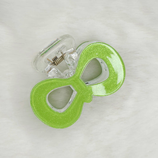 Green glittery hair claw on a white background