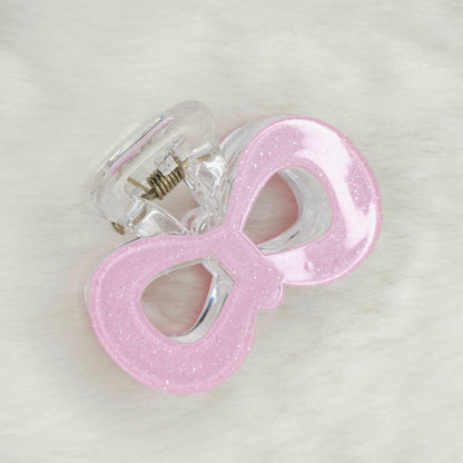 Rose glitter pop bow hair claw clip with sparkling finish, stylish and elegant accessory for securing hair.