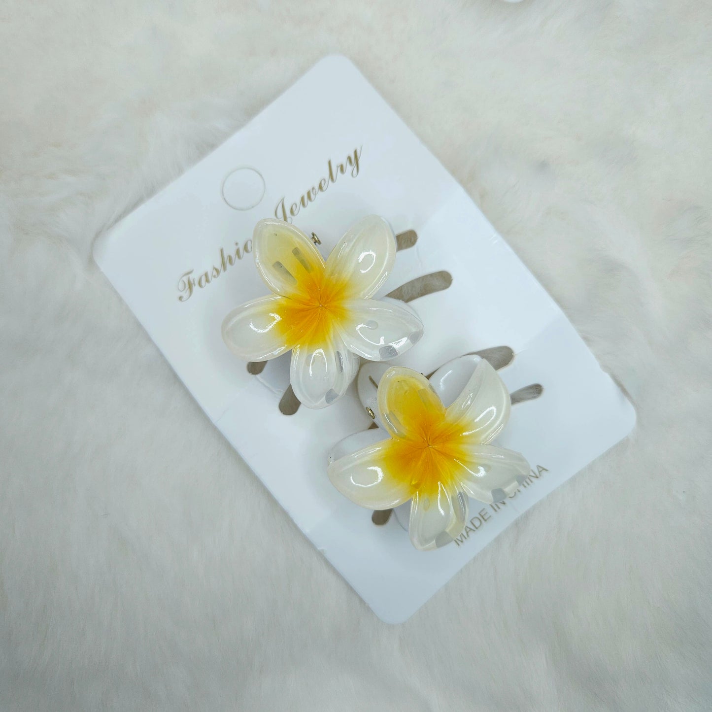 Flower-shaped hair clips on a 'Fashion Jewelry' card with a light background