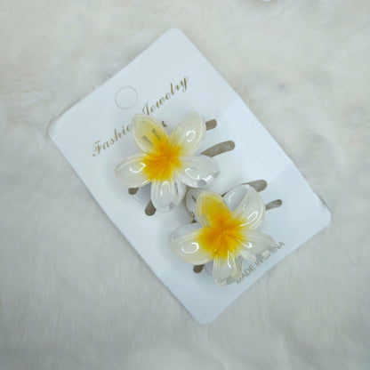 Flower-shaped hair clips on a 'Fashion Jewelry' card with a light background