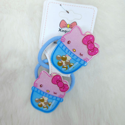 Two Hello Kitty-themed hair ties with packaging on a light background