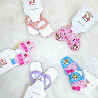 Colorful children's hair ties with cartoon designs on white background
