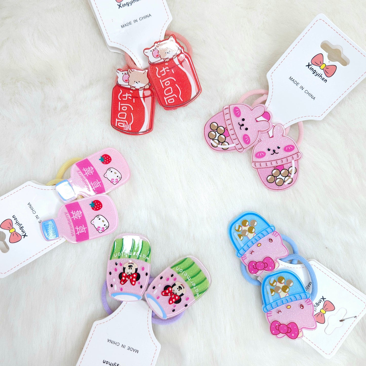 Set of colorful hair ties with cartoon designs on a white background
