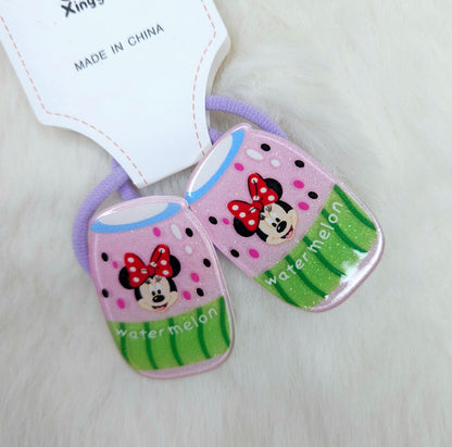 Two cartoon-themed hair ties with a watermelon design on a light background.