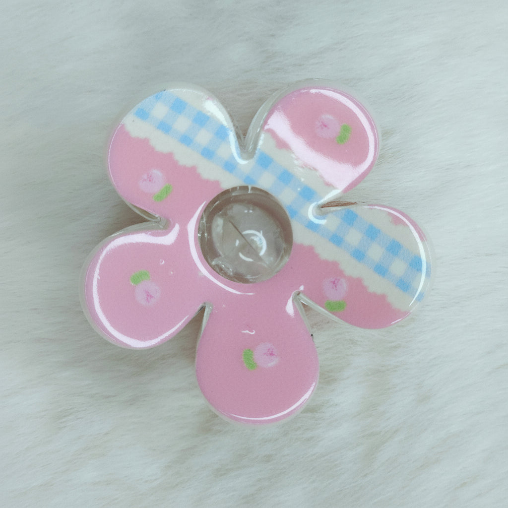 Pink and white kawaii floral hair claw accessory with dainty rose print and clear glossy surface.
