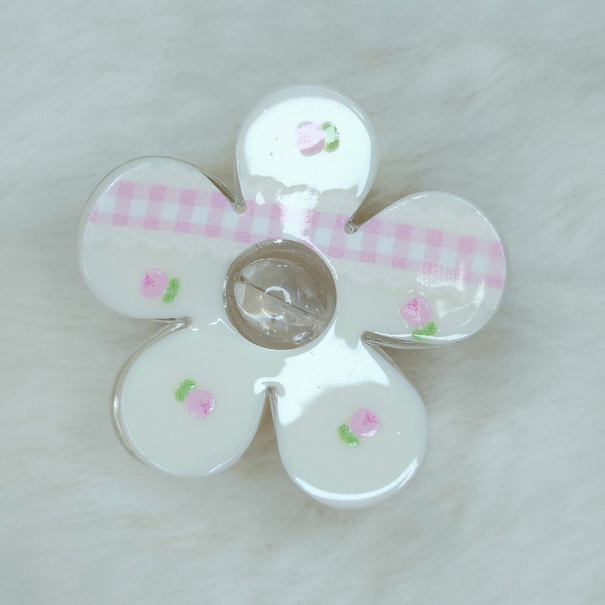 White flower claw clip featuring pink gingham kawaii pattern and soft rose decorations.