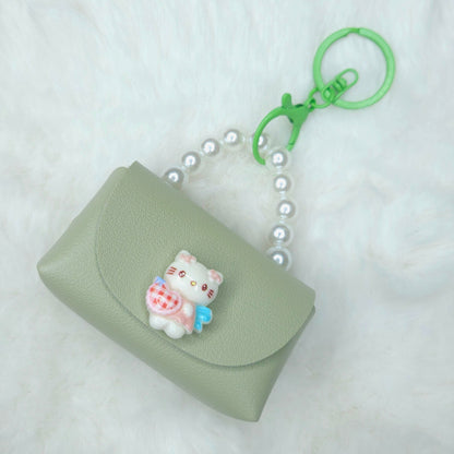 Green keychain pouch with a cat charm on a white background