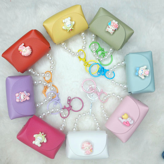 Colorful key cases with keychains arranged in a circular pattern on a light background.
