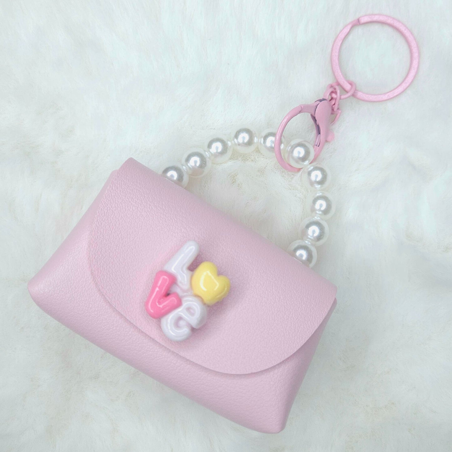 Pink pouch with decorative elements on a white background