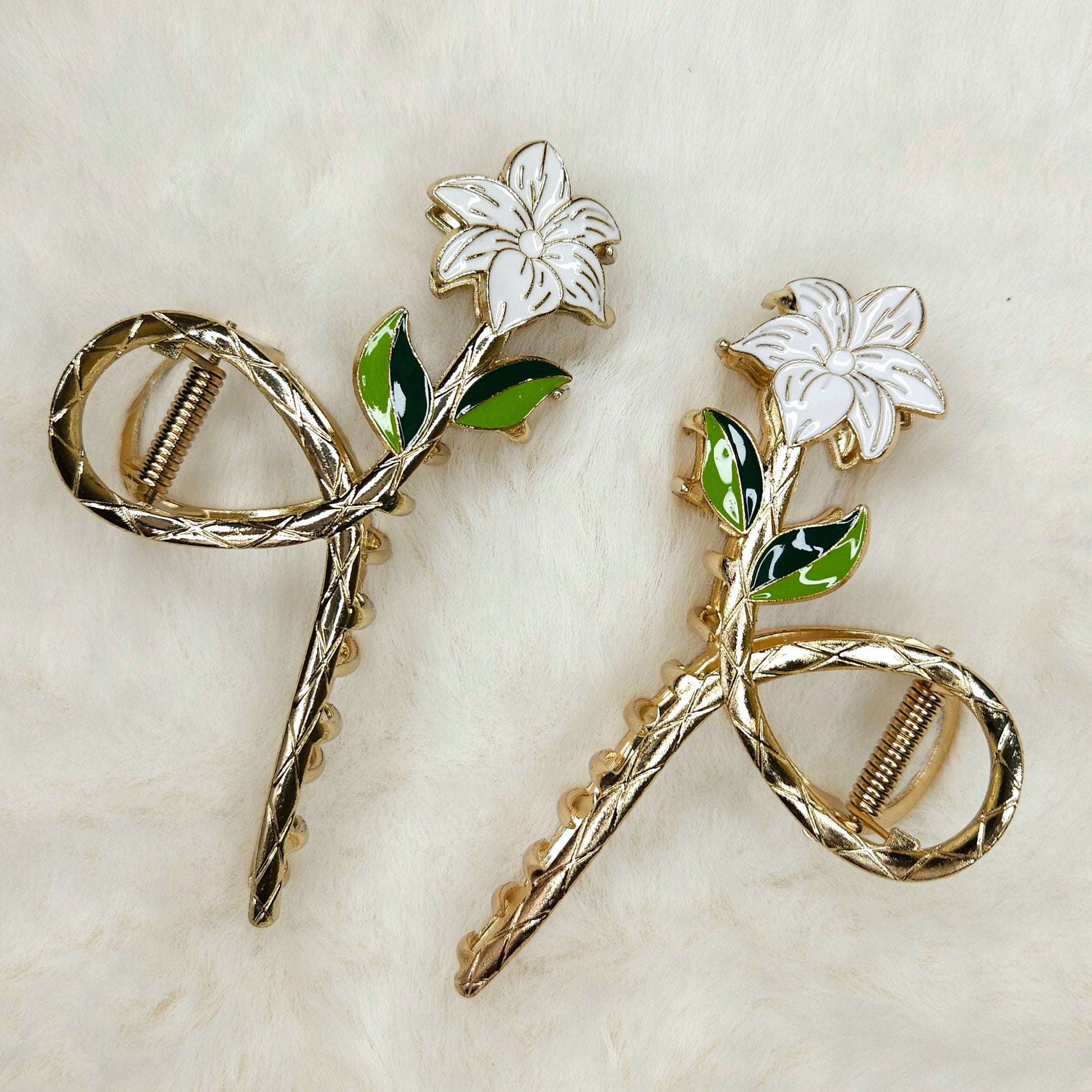 Pair of floral hair pins on a textured beige background