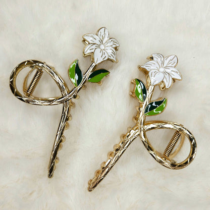 Pair of floral hair pins on a textured beige background
