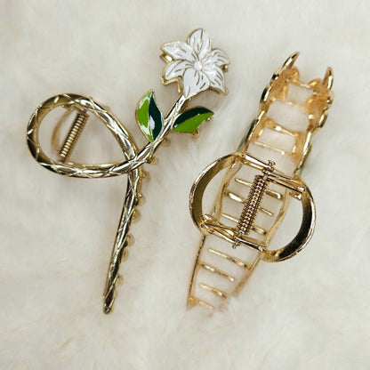 Gold hair accessories with floral design on a white background