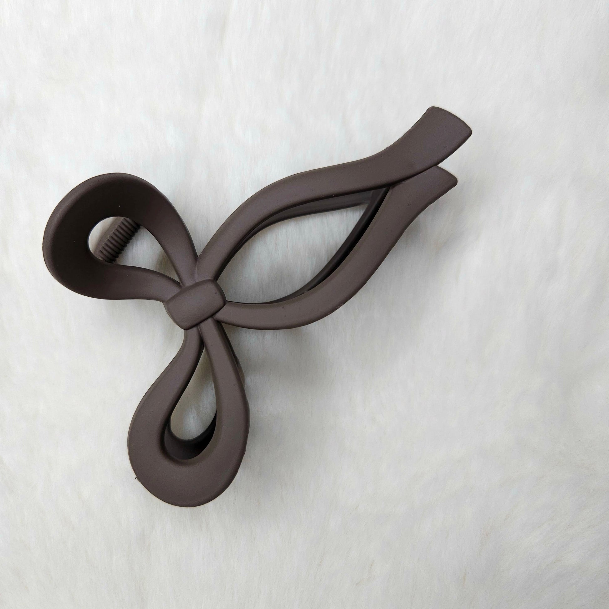 Brown color bow-shaped hair claw clip on a white background