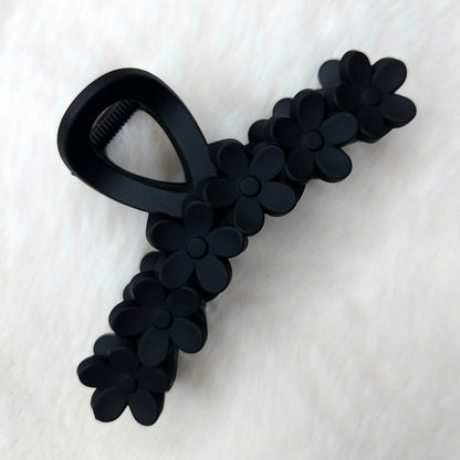 Black floral-patterned hair claw on a white background