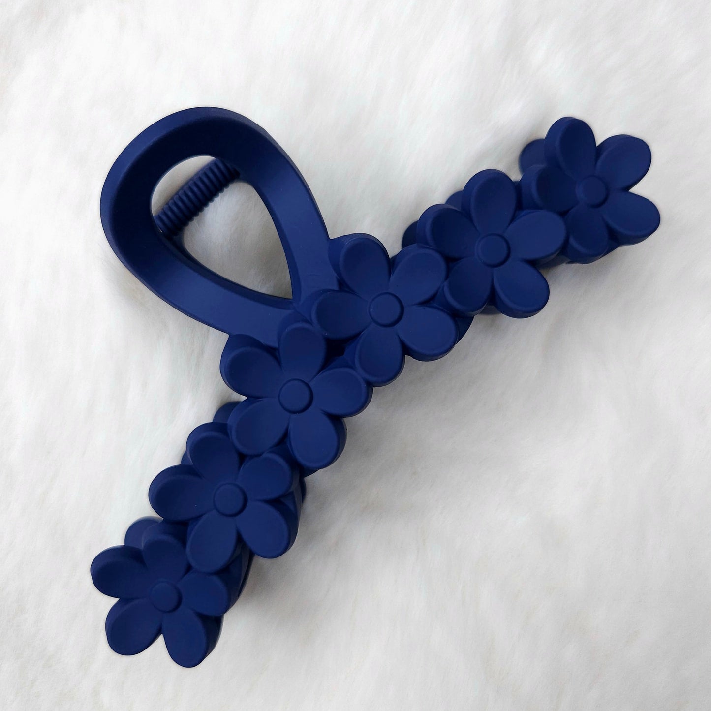 Blue floral-patterned hair claw on a white background