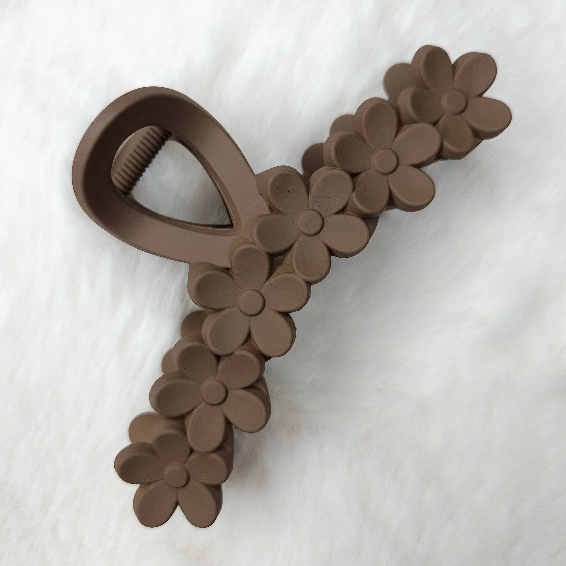 Brown floral hair claw on a white background