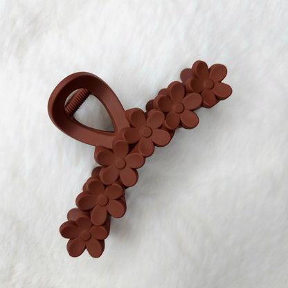 Brown floral-patterned hair claw on a white background
