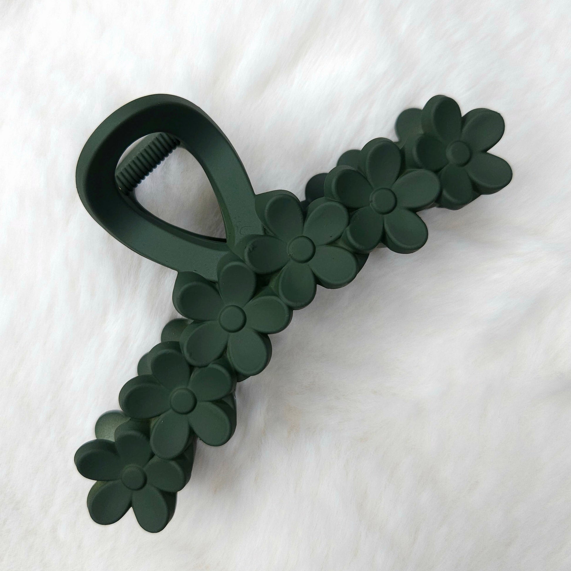 Dark green floral-patterned hair claw on a white background