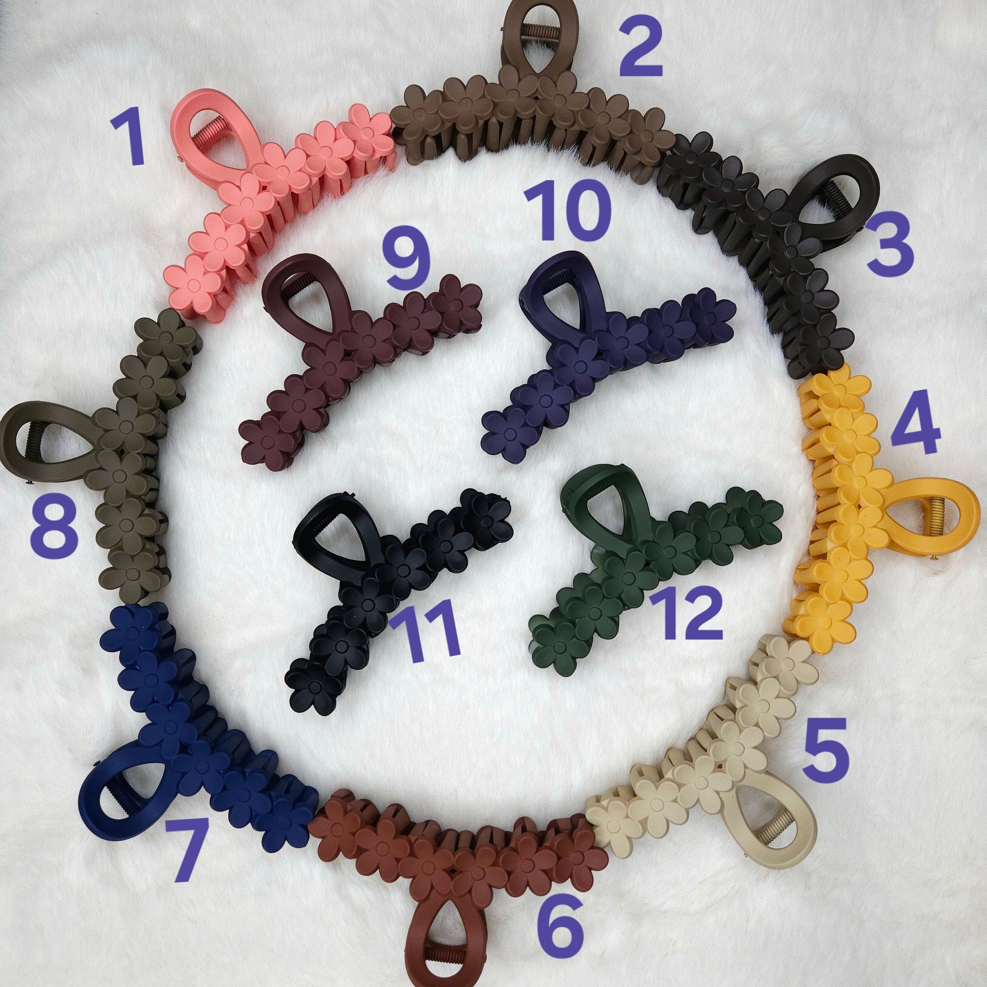 Set of colorful hair claw clips arranged in a circular pattern on a white background.