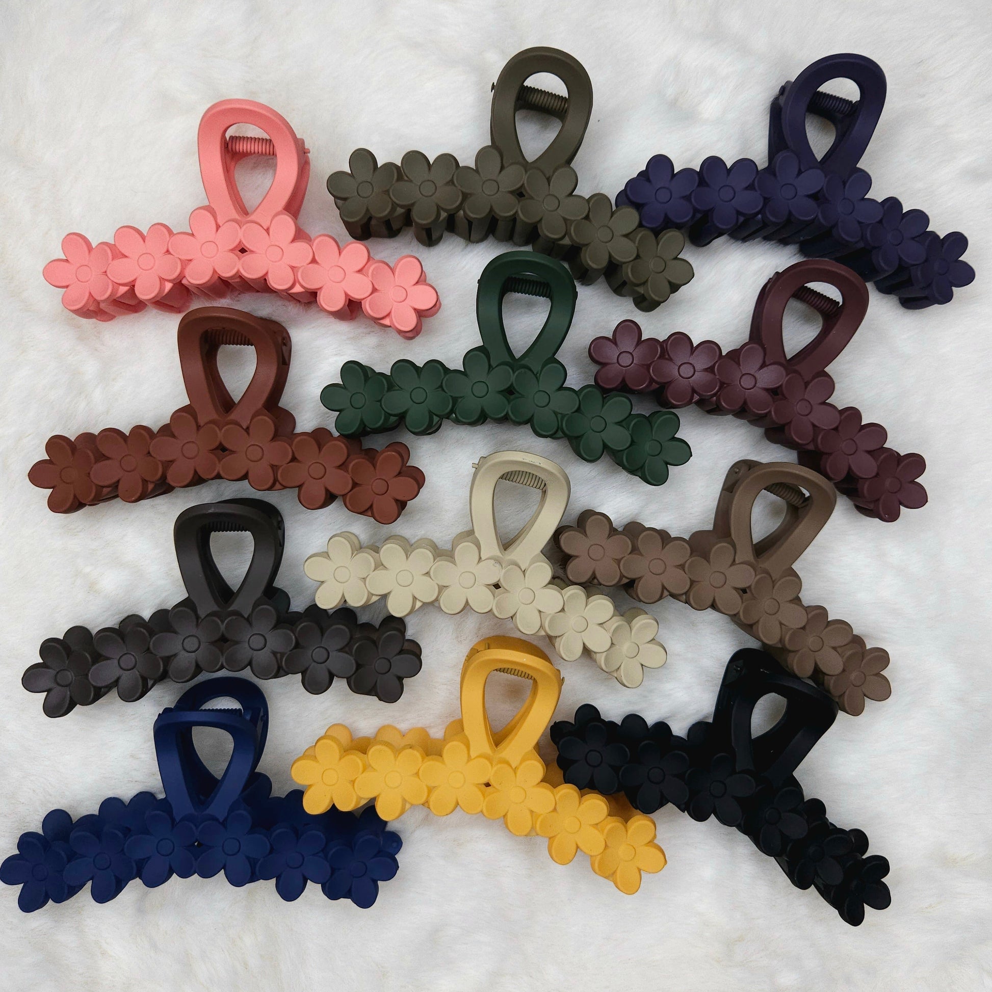 Set of colorful hair clips on a textured white background