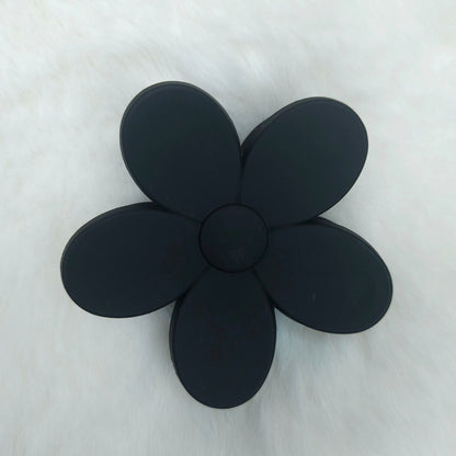 Black flower-shaped hair claw on a white background