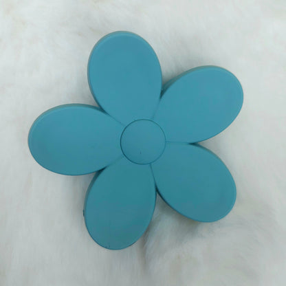 Blue flower-shaped hair claw on a white background