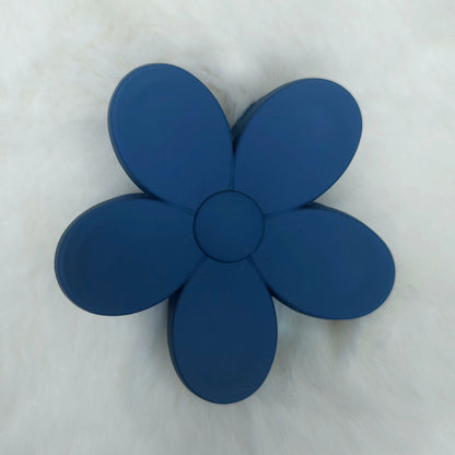 Blue flower-shaped hair claw on a white background