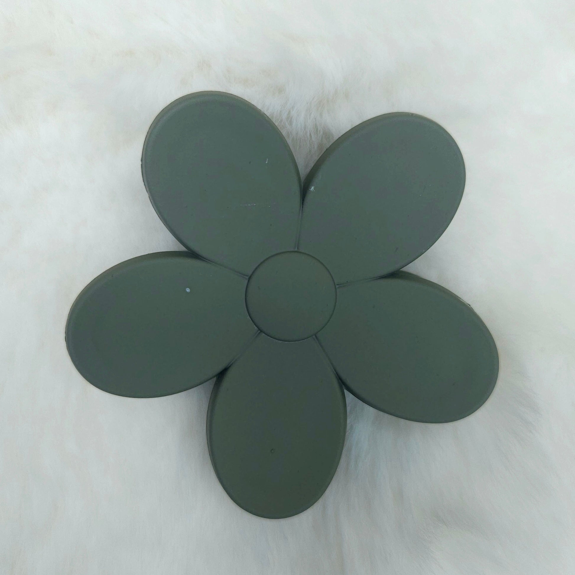 Dark green flower-shaped hair claw on a white background