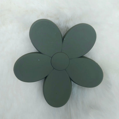 Dark green flower-shaped hair claw on a white background