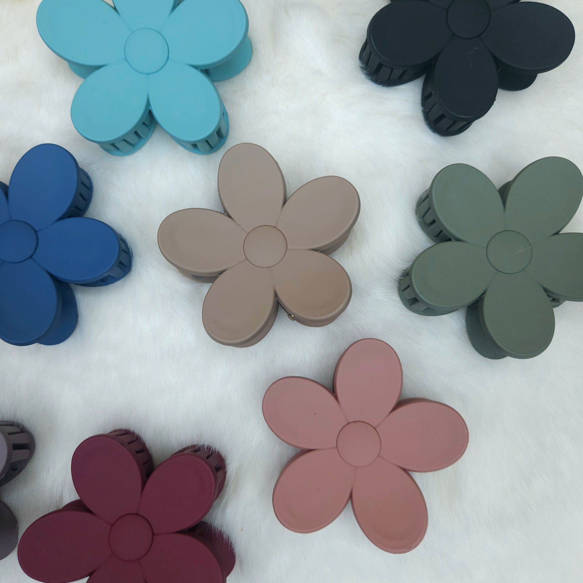 Colorful flower-shaped hair claws on a white background